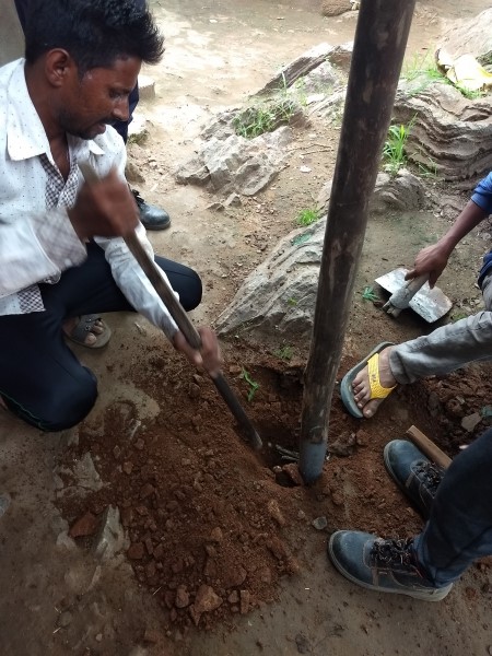 Workers digging hole in Tuvar Village