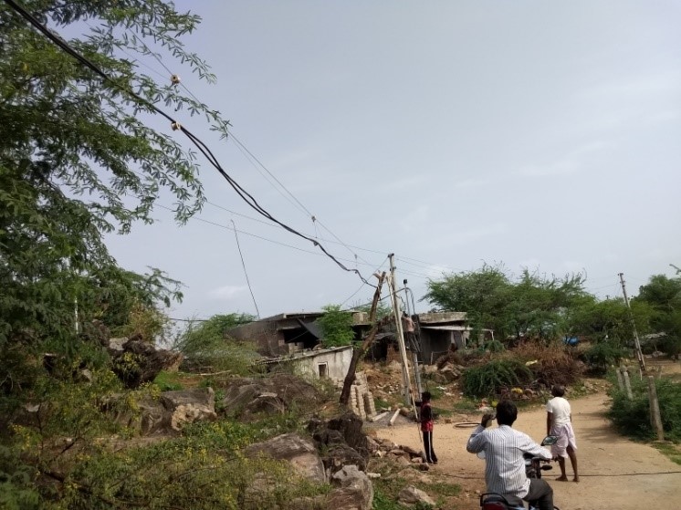 Workers examining installed power lines in Tuvar